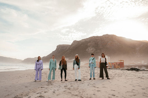 Not I But We's models wearing the aw24 clothing collection at the beach in Muizenberg