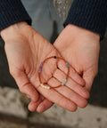 Calm Bracelet with colorful beads presented on someone's hands.