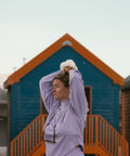 Thistle Knit Sweater in front of a Beach Hut