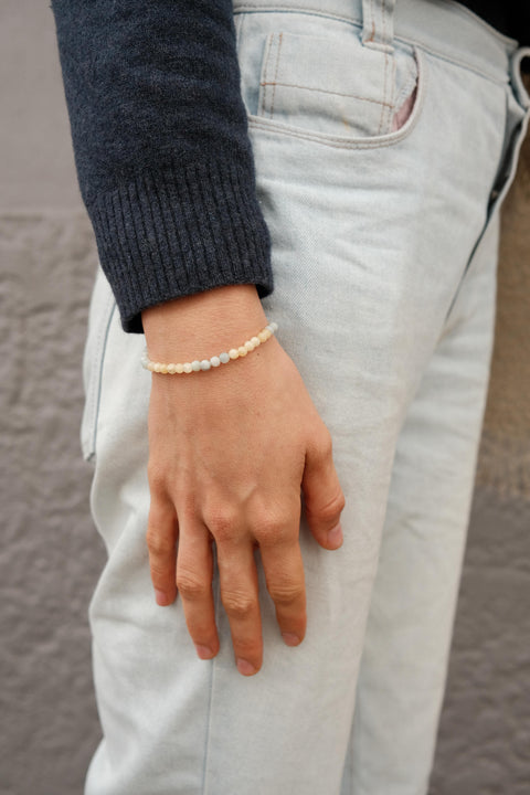 Breathe Bracelet worn by a woman with a blue jumper.