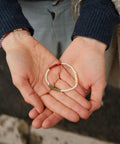 The gratitude bracelet with green, red, and white beads.