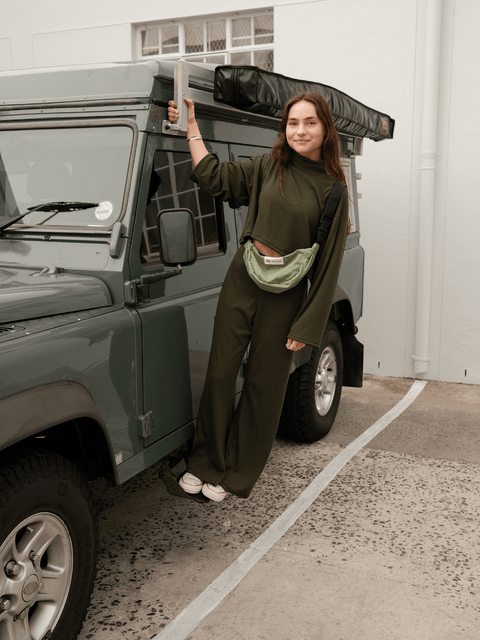 Green Moonbag worn by a young woman