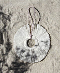 White linen Snowflake Ornament in the sand