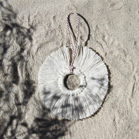 White linen Snowflake Ornament in the sand