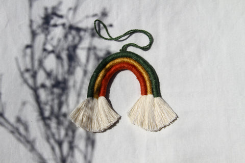 Mini macramé rainbow in green, gold, and red