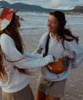 Two woman having fun while wearing Not I But We's patchwork moonbag and bucket hat.