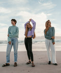 three people wearing Not I But We's tops at the Beach in Muizenberg, Cape Town