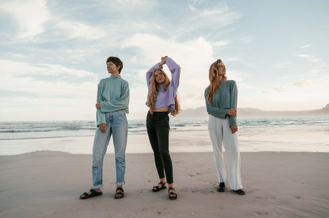 three people wearing Not I But We's tops at the Beach in Muizenberg, Cape Town