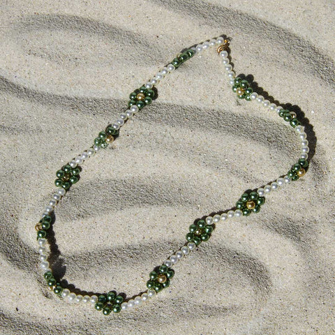 Green Daisy chain in the sand